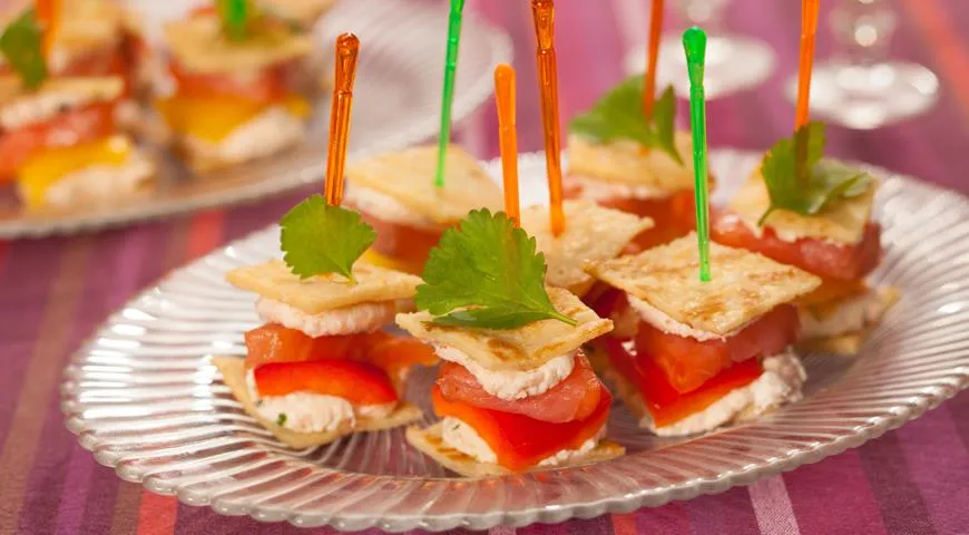 Appetizer skewers with cheese, vegetables, and herbs.