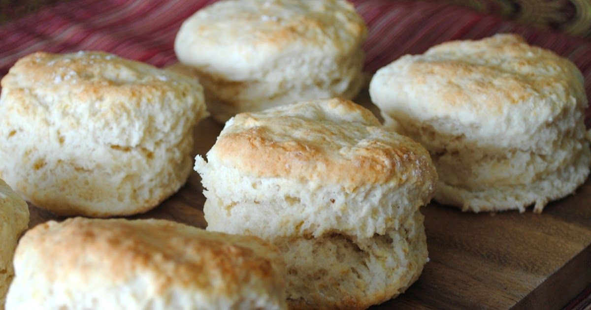 Freshly baked golden-brown biscuits stacked together.