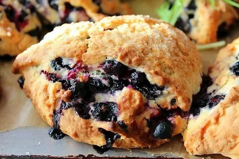 Close-up of a blueberry muffin with juicy berries inside.