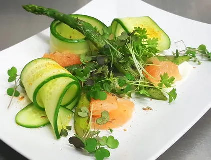 Elegant salad with smoked salmon, cucumber ribbons, and microgreens.