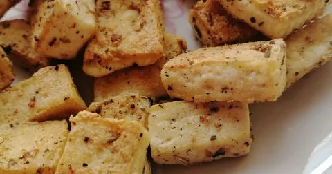 Close-up of seasoned tofu cubes.