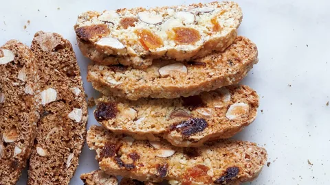 Close-up of sliced nut and fruit bread.