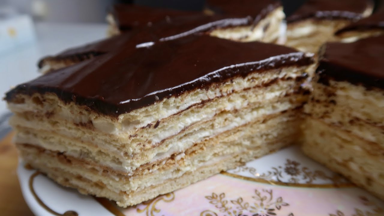 A multi-layered cake with chocolate glaze.