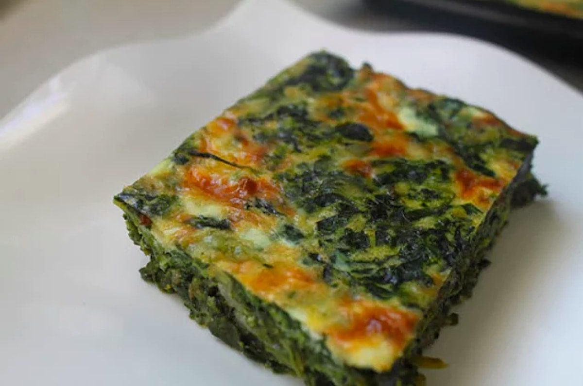 A square piece of spinach and cheese casserole.