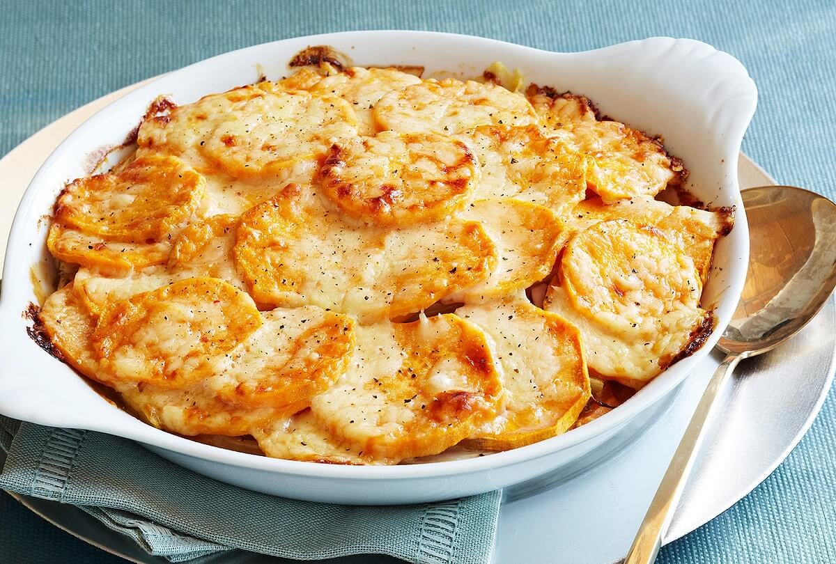 Golden scalloped potatoes baked in a creamy cheese sauce.
