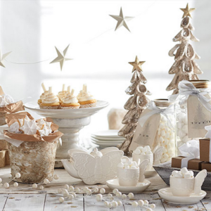 Elegant Christmas table setting with white and gold decorations.