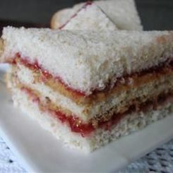 Close-up of layered coconut and jam sandwich slices.