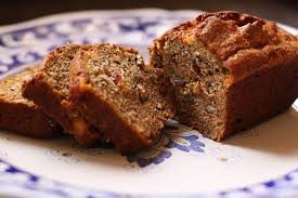 Sliced nut bread on a decorative plate.