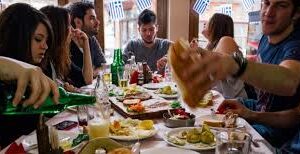 Friends enjoying a lively meal together at a festive table.
