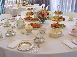 Elegant dining table set with fine china and floral centerpiece.