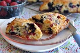 Freshly baked blueberry muffins on a plate.