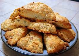 A plate of freshly baked scones with a golden crust.
