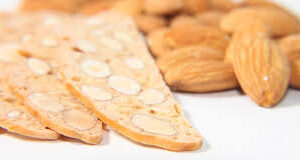 Close-up of almond biscotti with a blurred background of pastries.