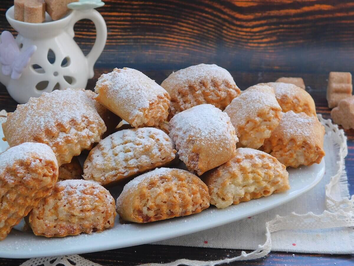 Plate of homemade pastries dusted with powdered sugar.