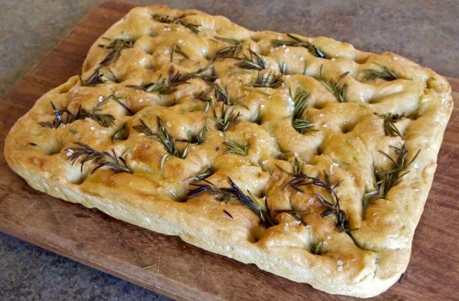 Freshly baked focaccia bread with rosemary on top.