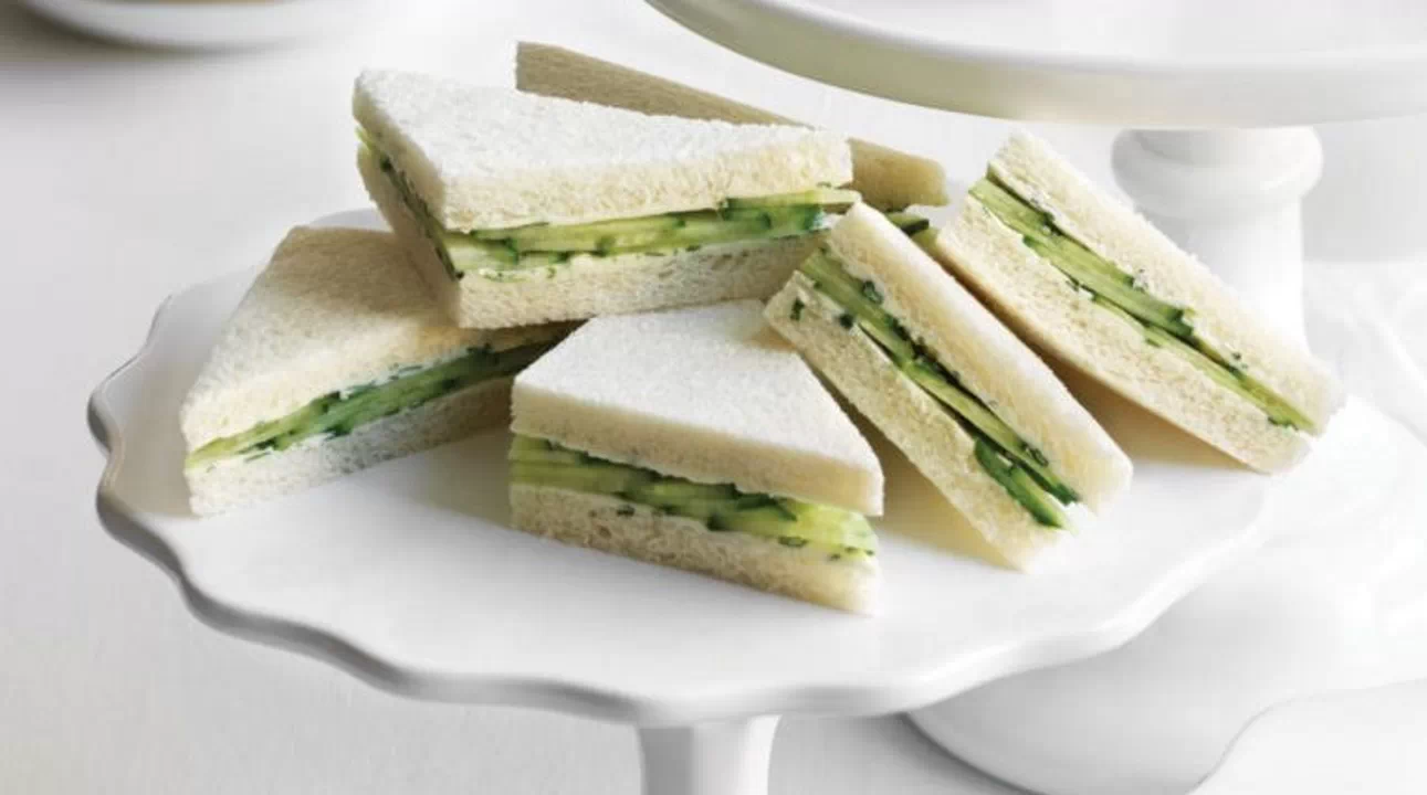 Cucumber tea sandwiches with white bread and creamy filling.