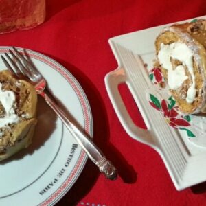 Two slices of cake on festive plates with a fork.