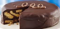 Chocolate cake with swirled filling and decorative icing on top.