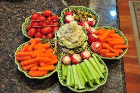 Colorful vegetable platter with dip in the center.