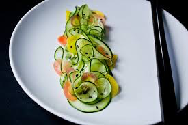 Elegant dish with thinly sliced cucumber and smoked salmon.