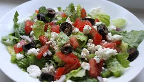 Fresh salad with olives, tomatoes, and feta cheese.
