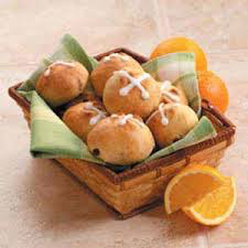 Basket of hot cross buns with orange slices.