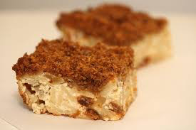 Two crumbly dessert bars with nuts and a creamy filling.