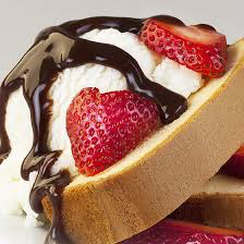 Close-up of strawberry cheesecake with chocolate drizzle.
