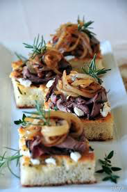 Elegant appetizers with caramelized onions and herbs on toasted bread.
