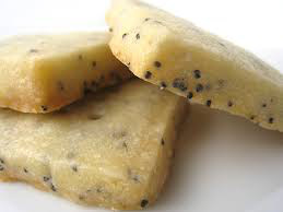Close-up of three sesame seed cookies on a white background.