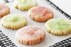 Close-up of colorful sugar cookies cooling on a rack.