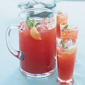 A pitcher and glasses of refreshing watermelon juice garnished with mint.