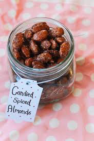 A jar of candied spiced almonds with a handwritten label.