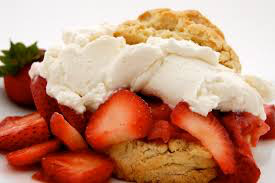Strawberries and cream on a biscuit.