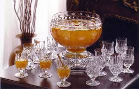 Elegant punch bowl with amber punch and matching crystal glasses.