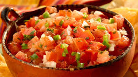 A bowl of fresh tomato salsa with onions and green peppers.