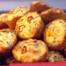Close-up of crispy fried fritters with visible herbs and spices.
