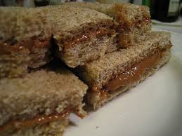 Close-up of layered caramel and crumb dessert bars.
