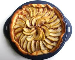A freshly baked apple tart with neatly arranged apple slices.