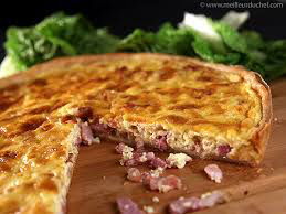 Close-up of a savory quiche with ham and cheese.