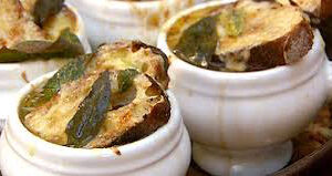 Close-up of baked stuffed eggplants in white ramekins.