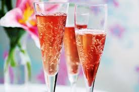 Three flutes of sparkling rosé with bubbles rising.