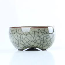 A small ceramic bowl with crackled glaze on a white background.