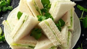 Fresh cucumber sandwiches with green garnish.