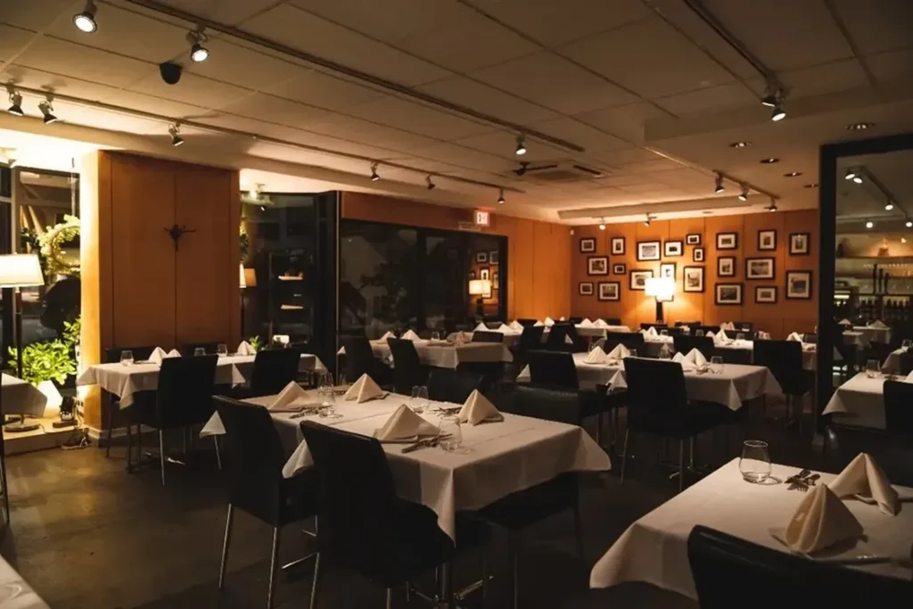 Elegant restaurant dining area with neatly arranged tables and warm lighting.