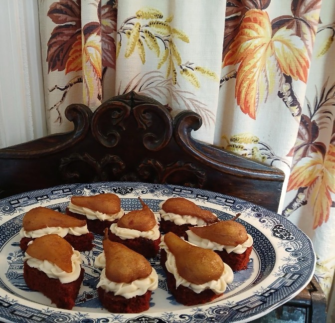 Heart-shaped chocolate cakes with cream on a decorative plate.
