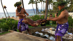 Men preparing traditional Hawaiian luau feast.