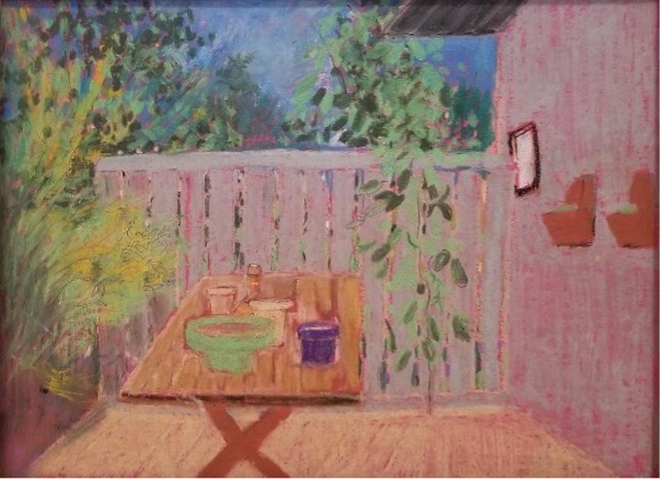 Colorful patio with table and plants.