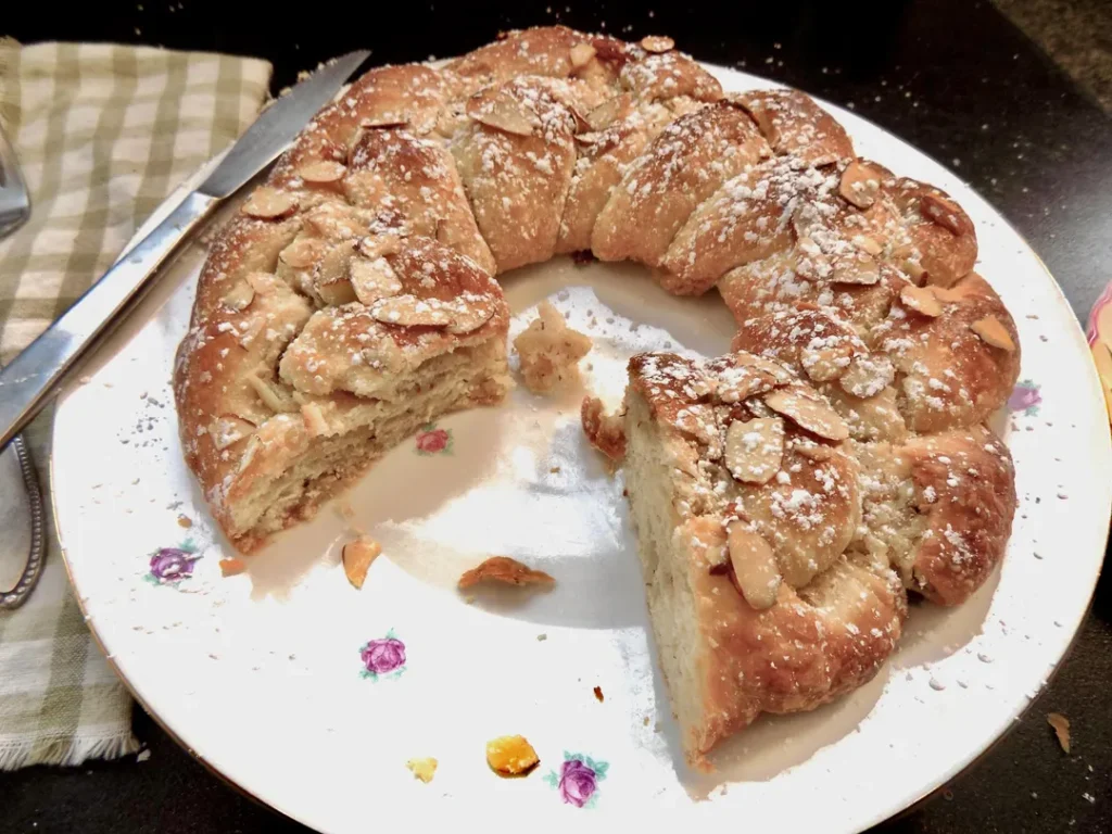 Almond pastry wreath on a decorative plate.
