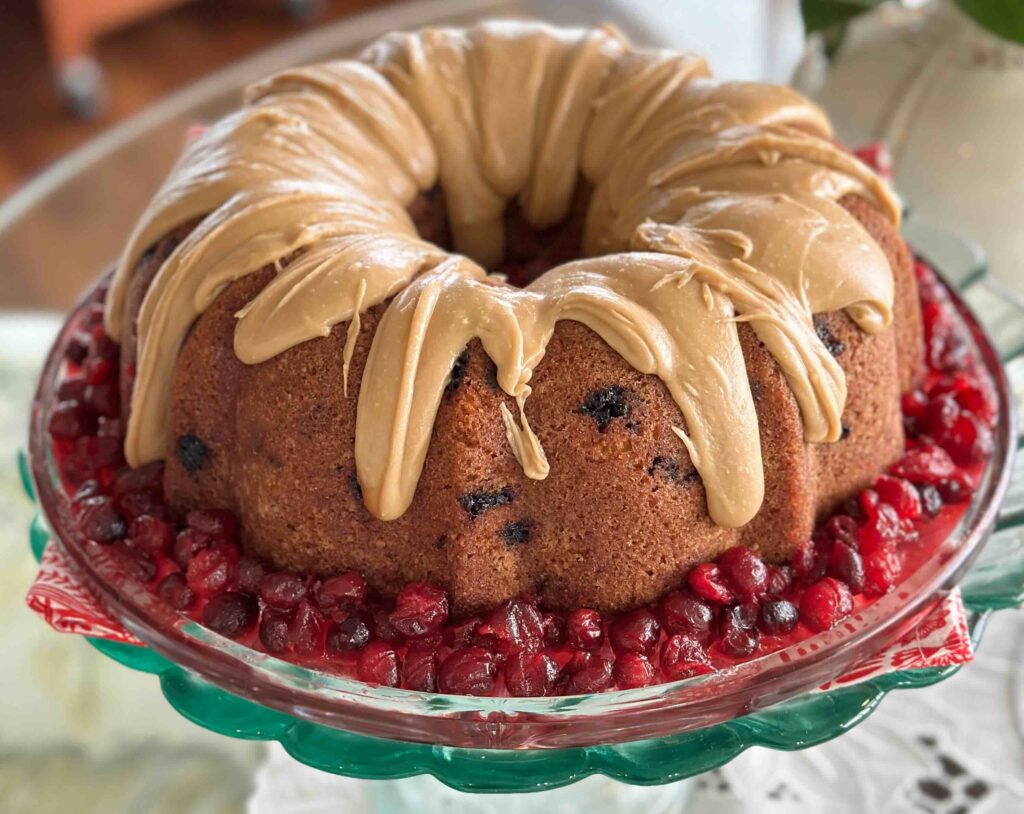 Bundt cake with glaze and red berries.
